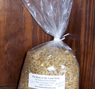 A bag of sunflower seeds sitting on top of a wooden shelf.