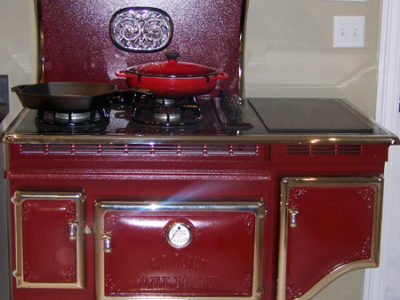 A red stove in a kitchen.