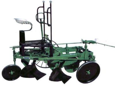 A green tractor with two plows and a seat.