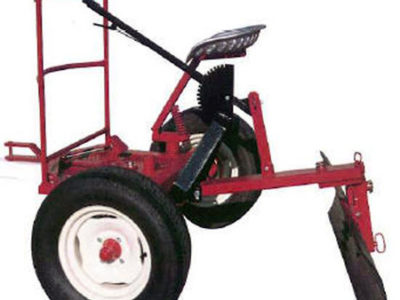 A red tractor with a shovel attached to it.