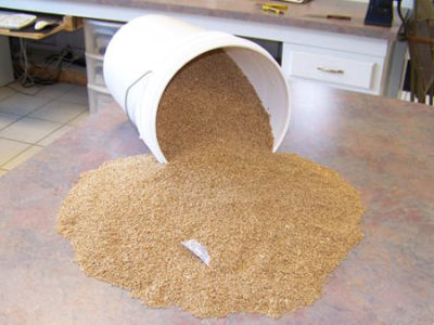 A bucket of sand sitting on top of a counter.